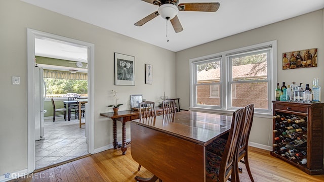 dining area with light wood-type flooring, plenty of natural light, and ceiling fan