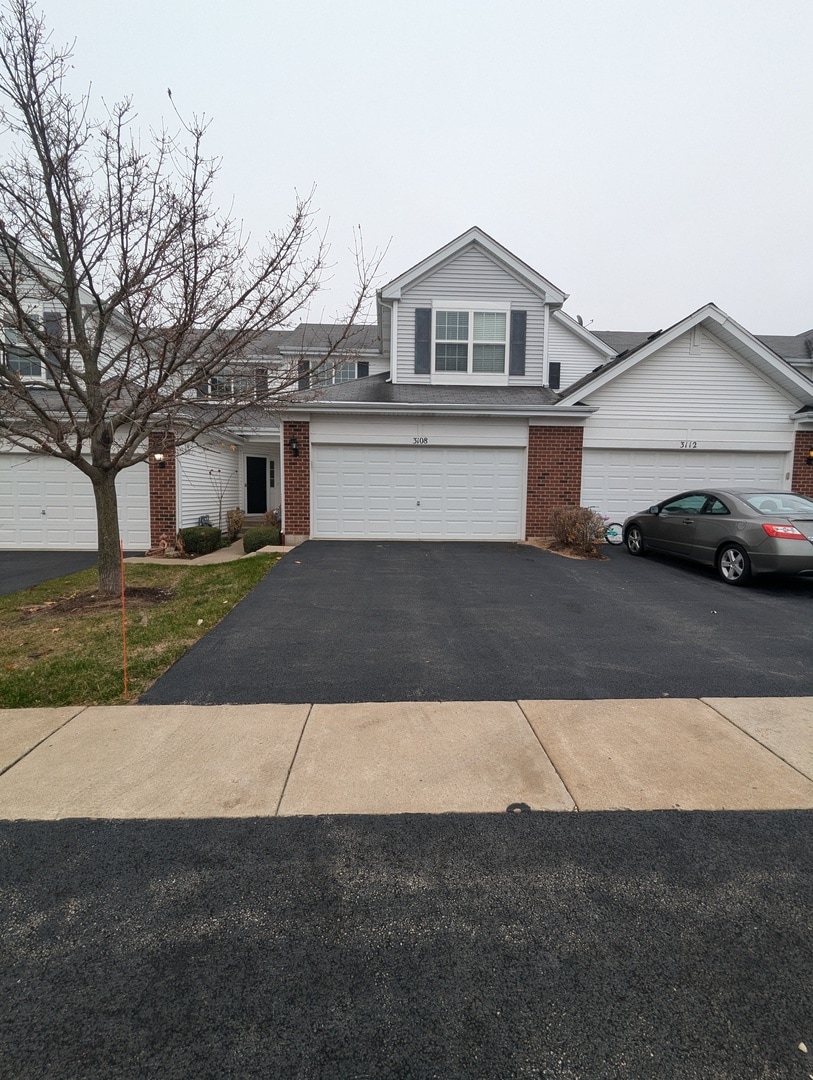 3108 Shenandoah Ln Unit 3108, Woodstock, IL 60098 - view of front of home featuring a garage