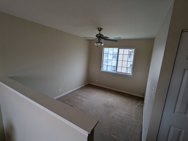 spare room featuring carpet flooring and ceiling fan