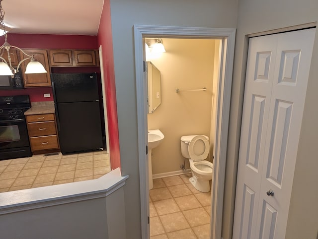 bathroom featuring tile patterned floors and toilet