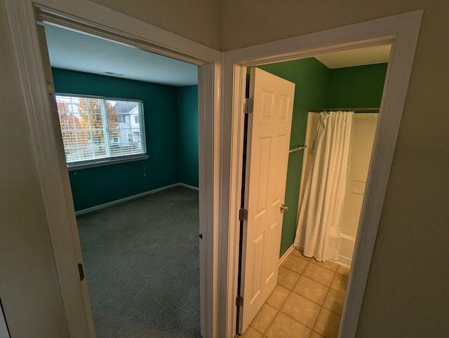 bathroom with tile patterned floors and shower / tub combo