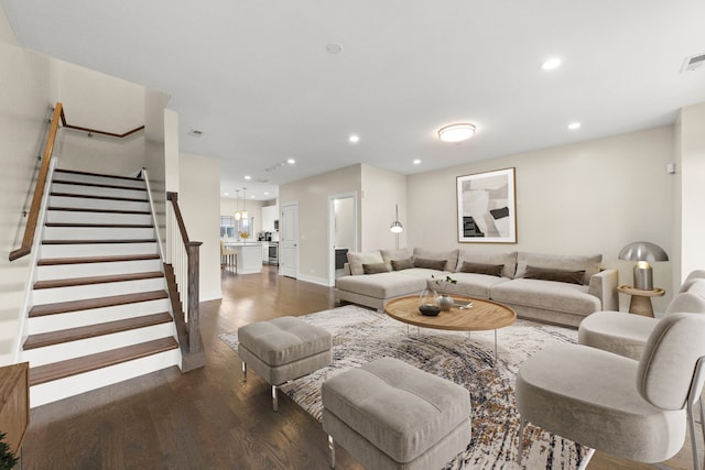 living room with dark hardwood / wood-style flooring