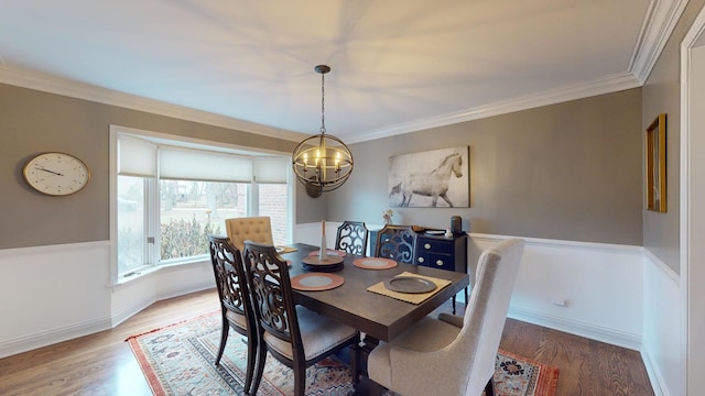 dining space with crown molding and hardwood / wood-style flooring