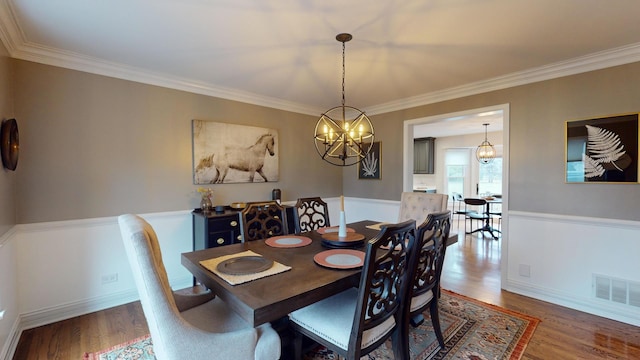 dining area with crown molding and dark hardwood / wood-style flooring