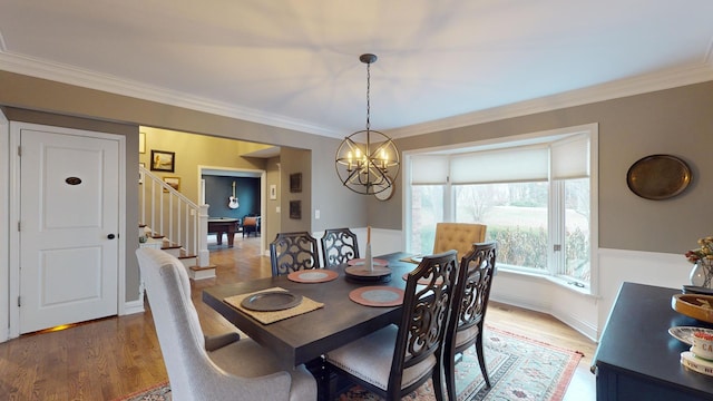 dining area with ornamental molding and hardwood / wood-style floors