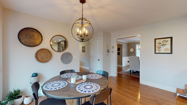 dining room featuring hardwood / wood-style floors and a notable chandelier