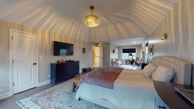 bedroom with an inviting chandelier and vaulted ceiling