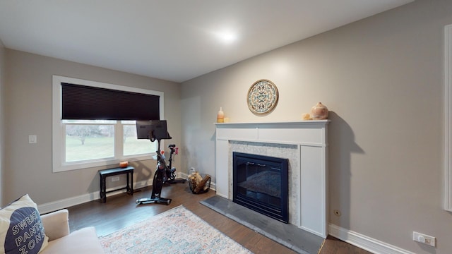 living room featuring dark hardwood / wood-style floors and a tile fireplace