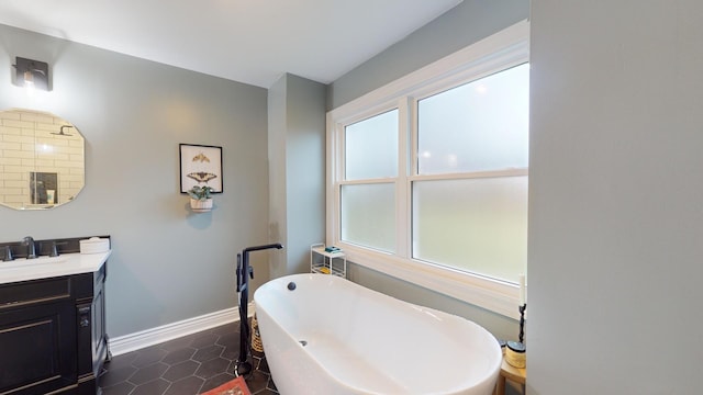 bathroom featuring vanity, tile patterned flooring, and a washtub