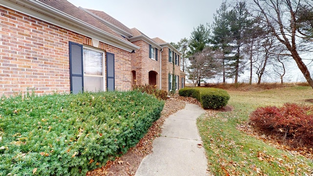 view of exterior entry featuring a yard