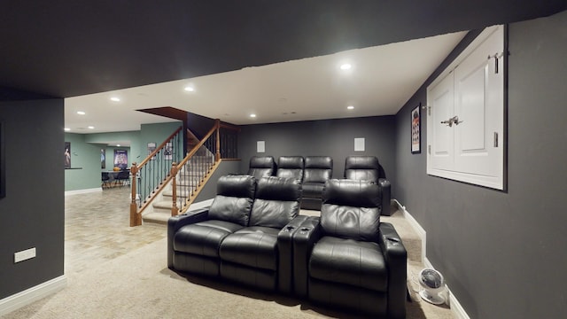 cinema room featuring light colored carpet