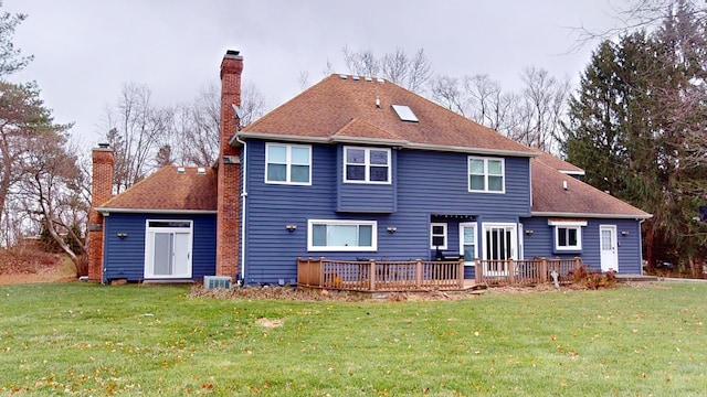 back of house featuring a wooden deck, central AC, and a lawn