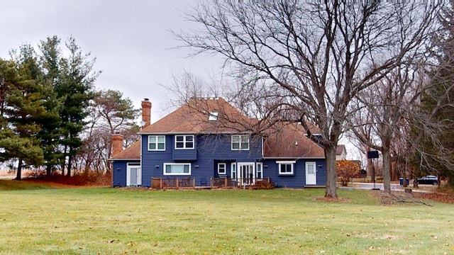 rear view of property with a yard