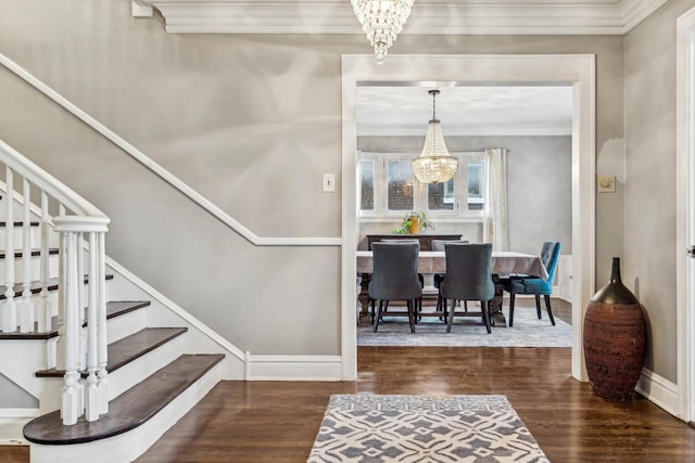 interior space with dark hardwood / wood-style flooring, crown molding, and a notable chandelier