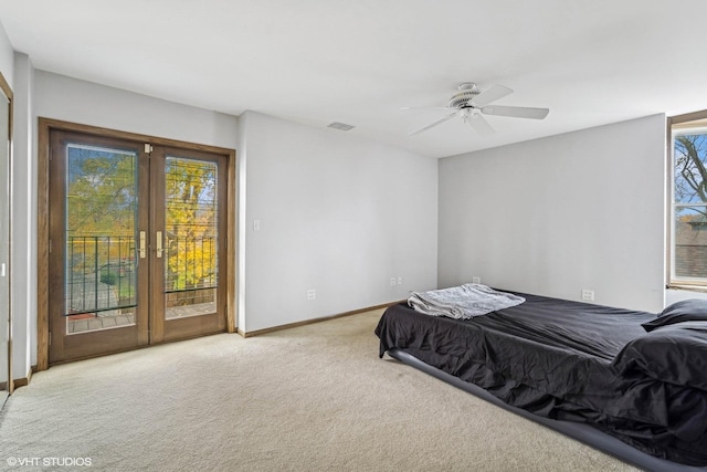 carpeted bedroom with access to exterior, ceiling fan, and french doors