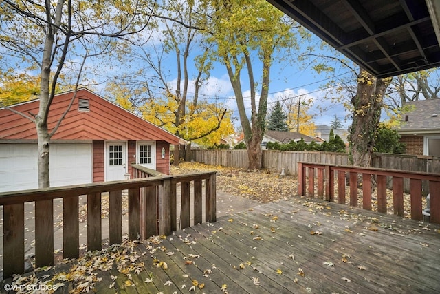 deck featuring an outdoor structure and a garage