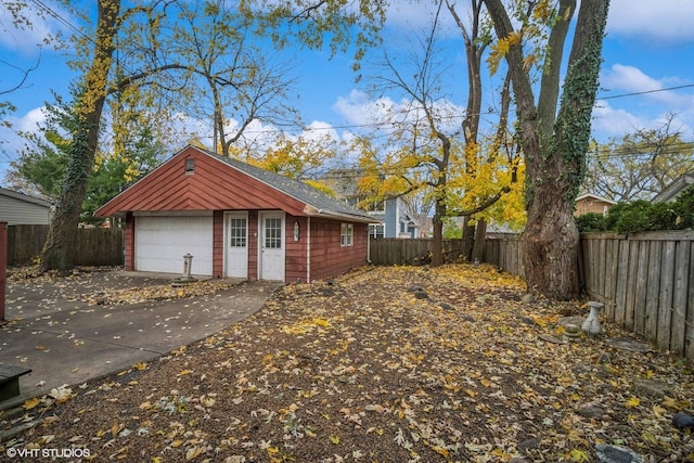 view of side of property with an outdoor structure and a garage