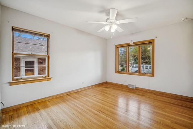 spare room with light hardwood / wood-style flooring and ceiling fan