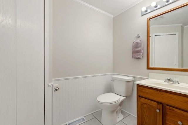 bathroom featuring tile patterned flooring, vanity, toilet, and ornamental molding