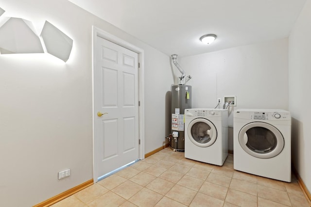 clothes washing area featuring light tile patterned flooring, washer and dryer, and gas water heater