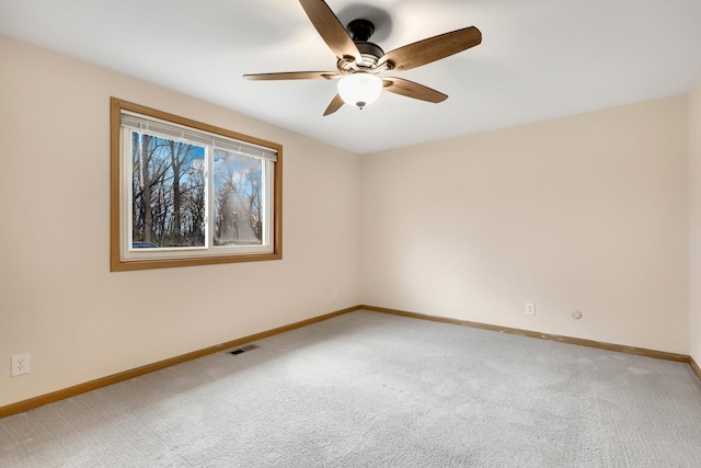 spare room featuring ceiling fan and carpet