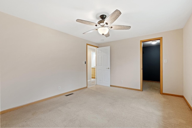 carpeted spare room featuring ceiling fan