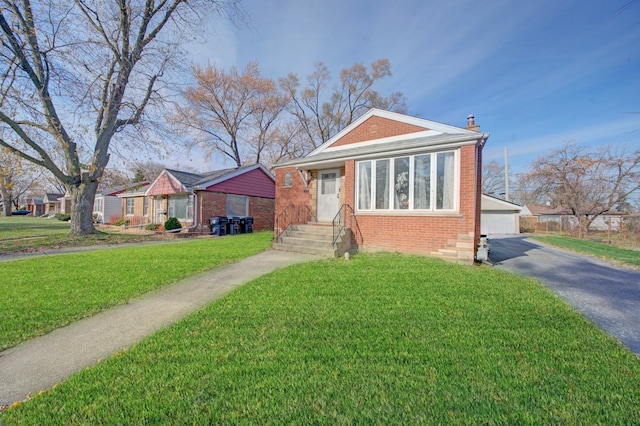 view of front facade with a garage, an outdoor structure, and a front yard