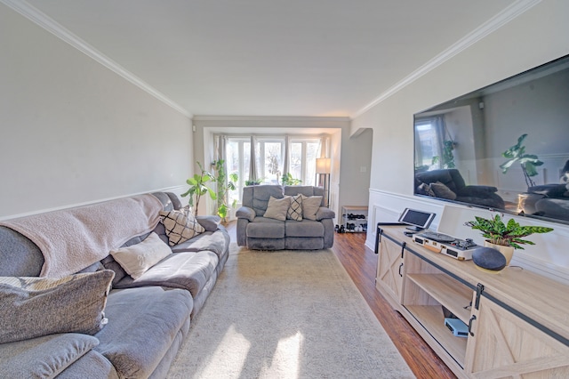 living room featuring wood-type flooring and crown molding