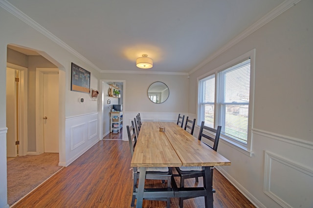 dining room featuring dark hardwood / wood-style floors and ornamental molding