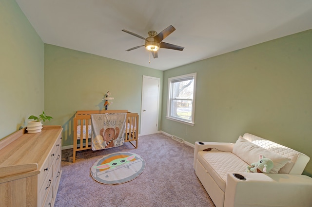 living area featuring ceiling fan and light colored carpet