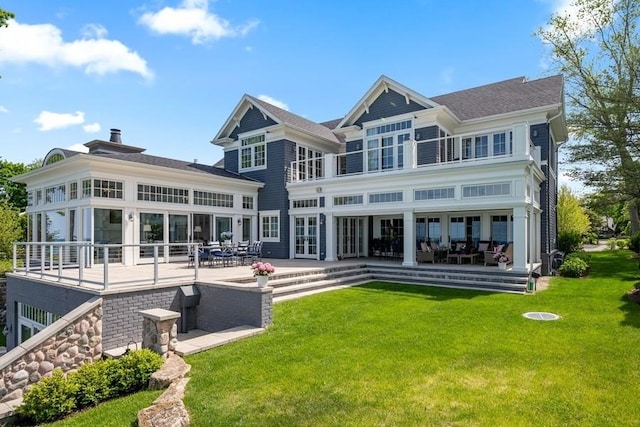 rear view of house featuring a lawn and a patio