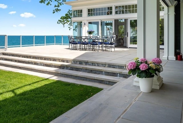 view of patio featuring a water view