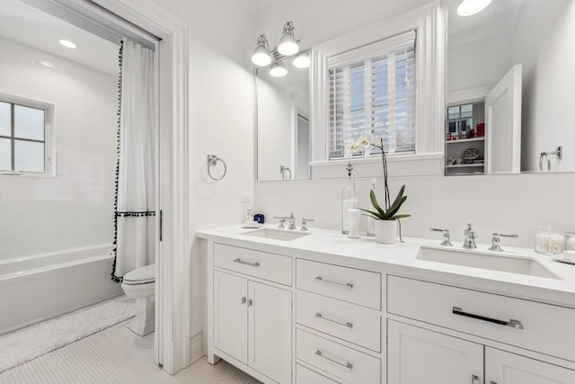 full bathroom featuring toilet, tile patterned flooring, vanity, and shower / bath combo with shower curtain