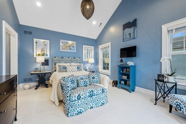 bedroom with high vaulted ceiling and light colored carpet