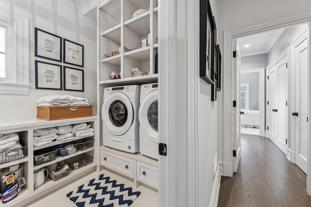 laundry area featuring independent washer and dryer and hardwood / wood-style flooring