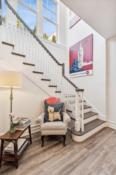 staircase featuring hardwood / wood-style flooring and a towering ceiling