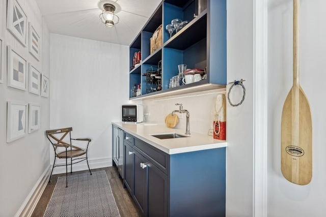 bar featuring dark wood-type flooring and sink