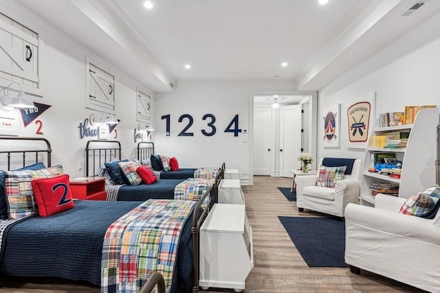 living room with ornamental molding and light hardwood / wood-style floors