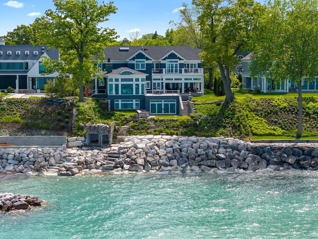 rear view of property featuring a water view