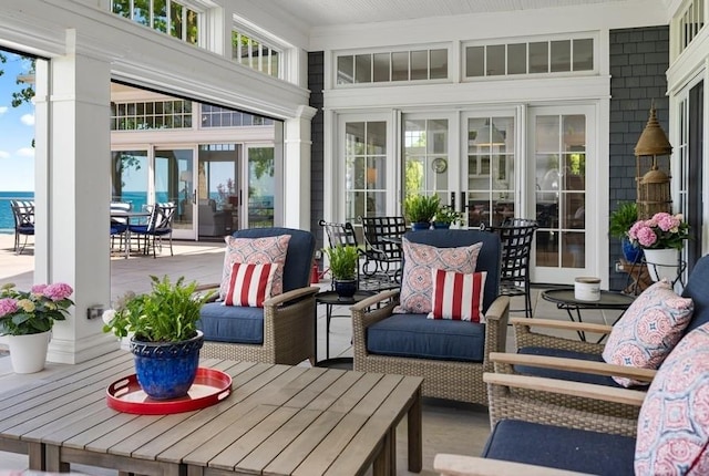 sunroom / solarium featuring a water view