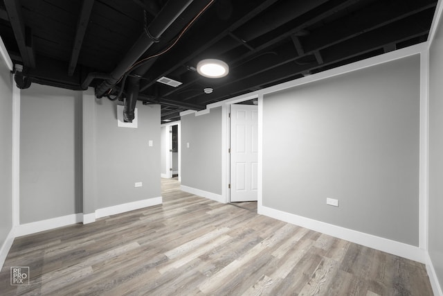 basement featuring hardwood / wood-style floors