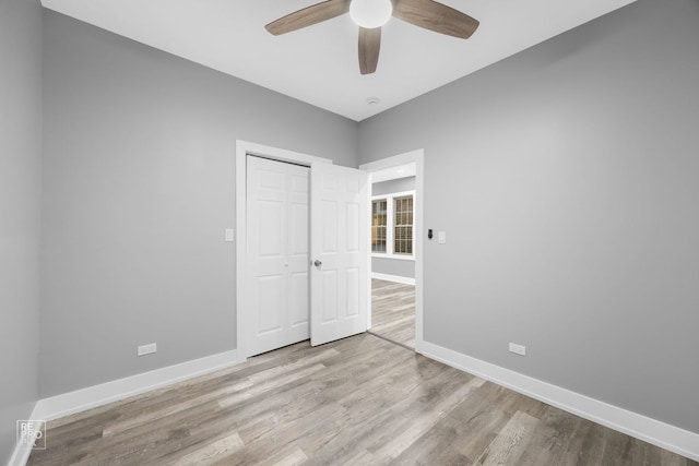 unfurnished bedroom with a closet, light hardwood / wood-style floors, and ceiling fan