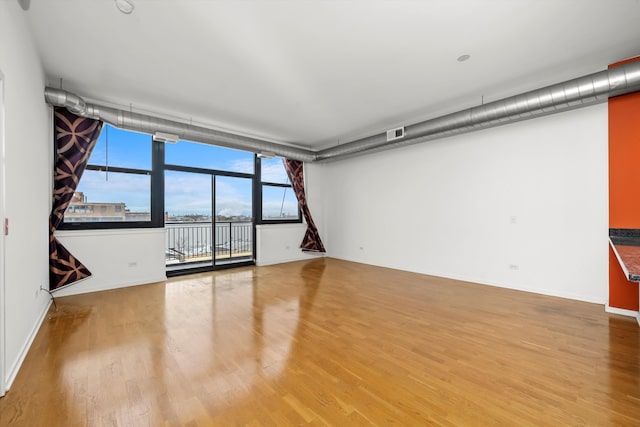 spare room with hardwood / wood-style floors