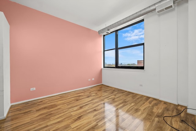 spare room featuring light wood-type flooring