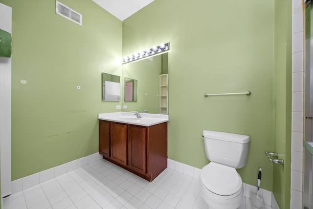 bathroom featuring tile patterned flooring, vanity, and toilet