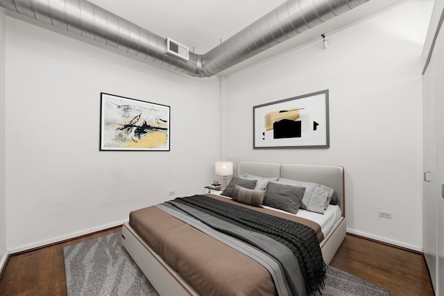 bedroom with dark wood-type flooring