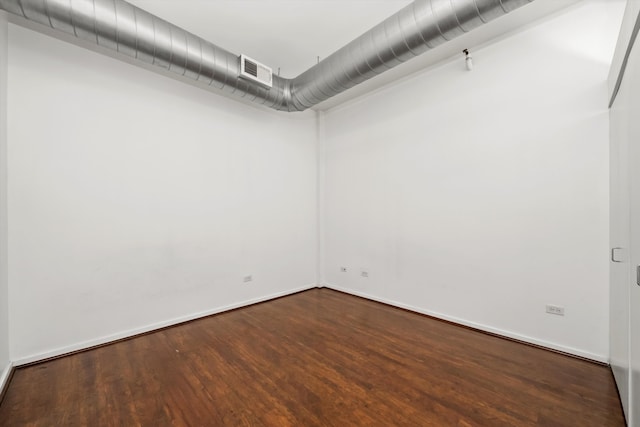 unfurnished room featuring dark wood-type flooring