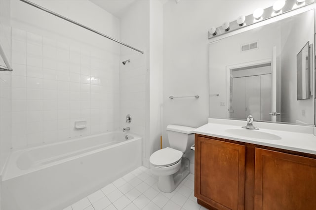 full bathroom featuring tile patterned floors, vanity, toilet, and tiled shower / bath combo