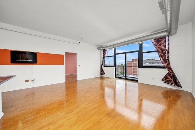 unfurnished living room with hardwood / wood-style floors