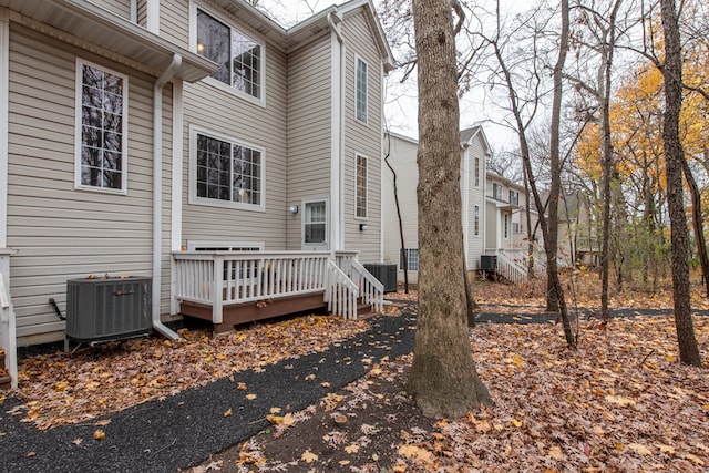 rear view of property featuring central AC unit and a deck